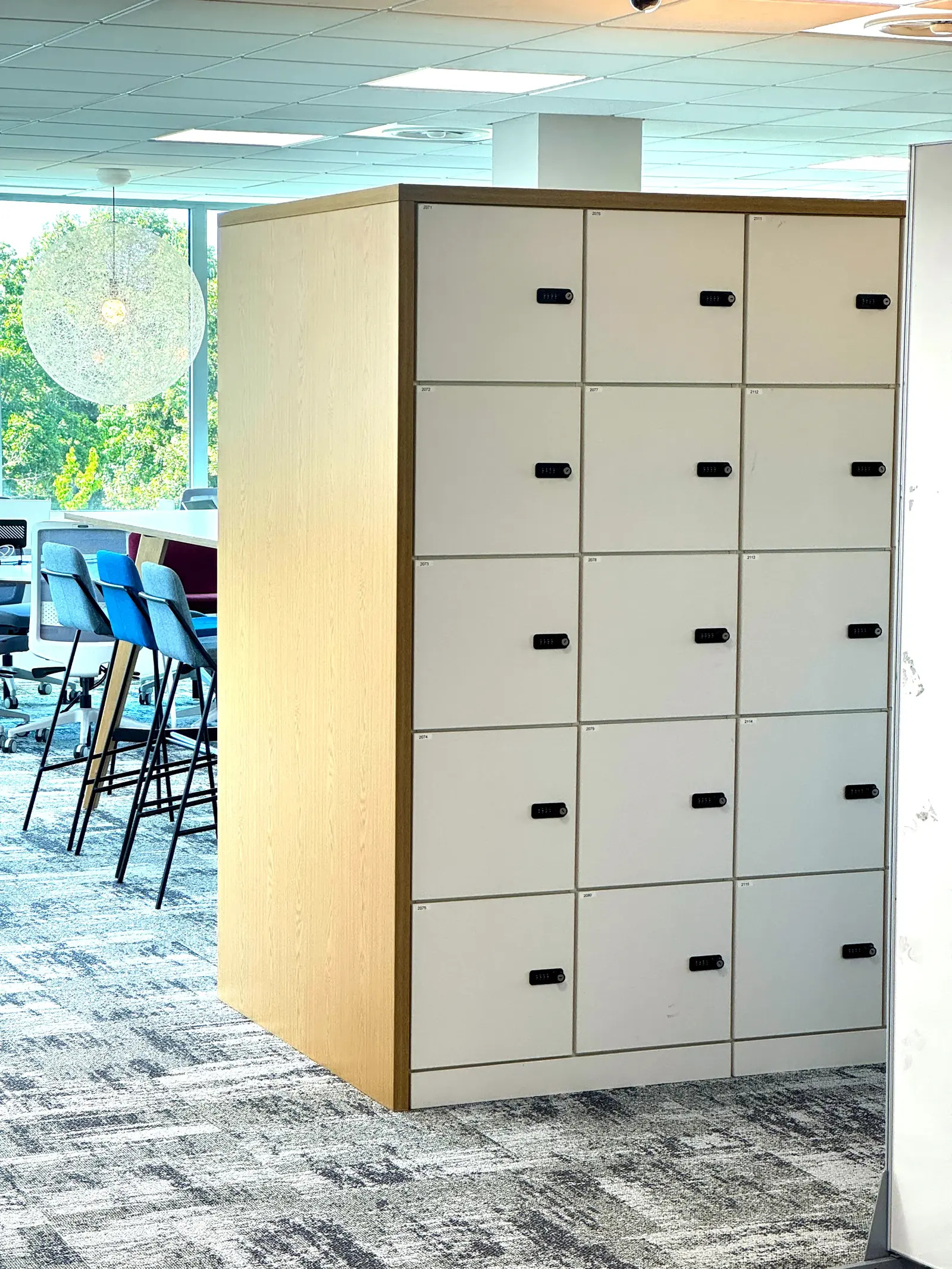 Custom locker shroud kit fitted over existing units in an office refurbishment
