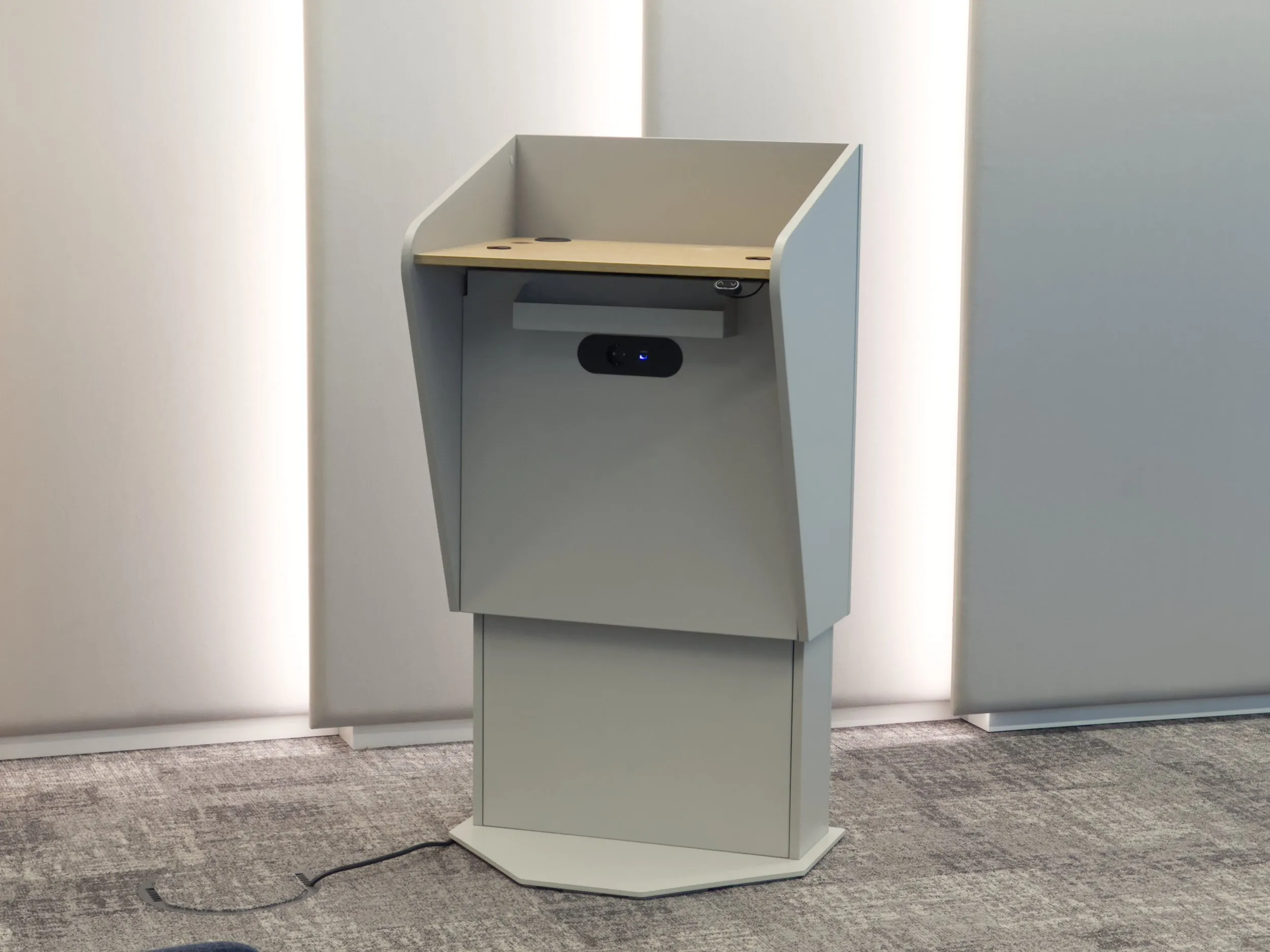 H.A.L. mobile height adjustable lectern front view in professional presentation setting